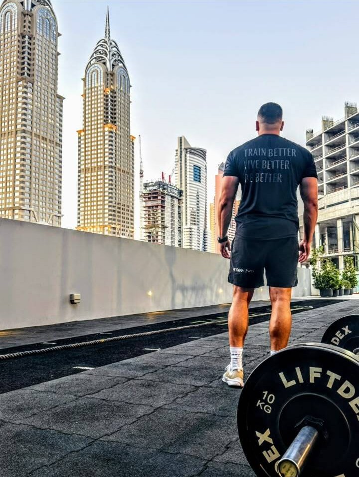 Christopher Mallett training on a rooftop gym overlooking the Dubai skyline